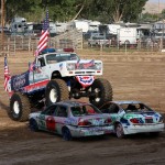 Before the Demolition Derby begins on Saturday, a monster truck parks in the center of the arena carrying the American Flags for the National Anthem. Dakoby Bentley
