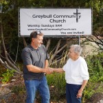 Pastor Aaron Gesch shakes hands with Kay Mattis outside the former Greybull Presbyterian Church on Monday afternoon. Gesch, lead pastor at Basin’s First Baptist Church, is helping Mattis and other church members transition to the new Greybull Community Church. Lisa Kunkel