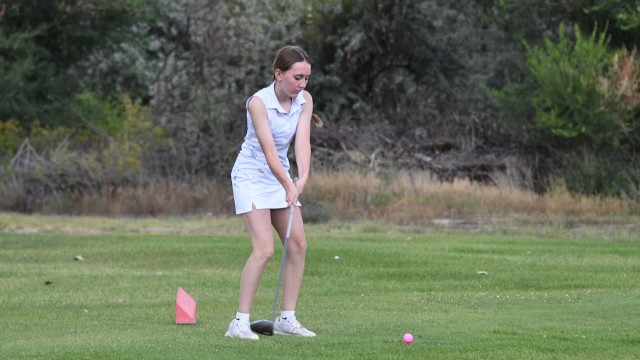 Shelby Hunt competes in a JV golf scramble in Lovell Tuesday night. David Peck