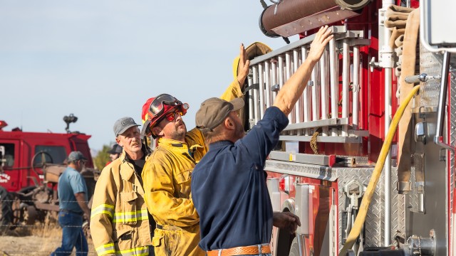 The Greybull fire crew helps with a structure fire on Lane 40 between Basin and Greybull on Saturday. Greybull volunteer firefighters are, second from left, Nate Hetzel, right, Chuck Spragg, and atop the fire truck, Nick Boyer. Michelle Olsen