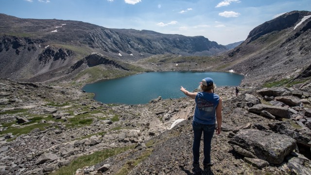 Elaina Howe of Lander points down at Florence Lake from the ascent of Bomber Mountain on Saturday, Aug. 1. Avery Howe
